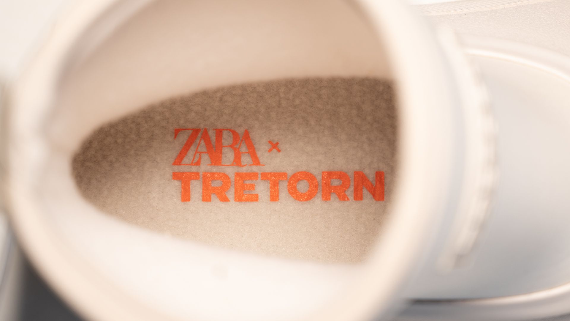 Close-up of the inside of a shoe showing the "ZARA x TRETORN" logo in red on the insole.